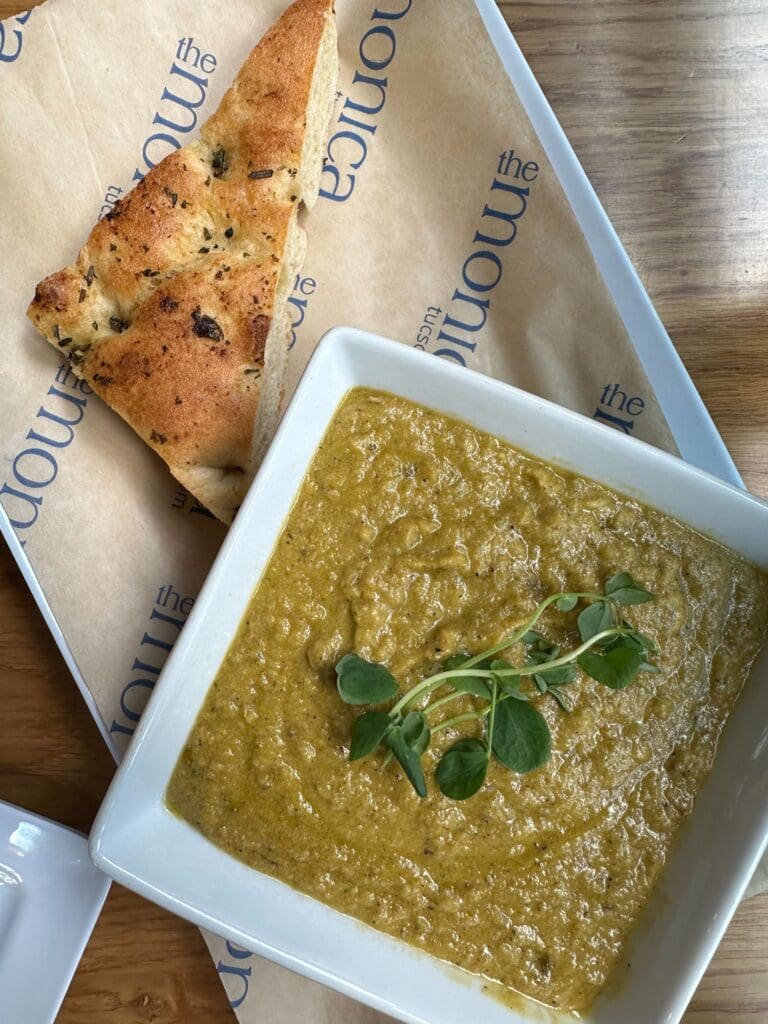 a plate of food and a spoon on a table