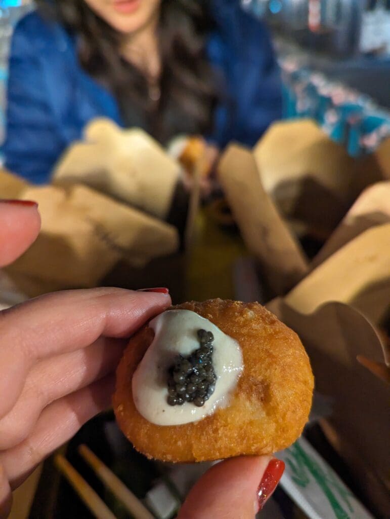 a hand holding a chocolate donut