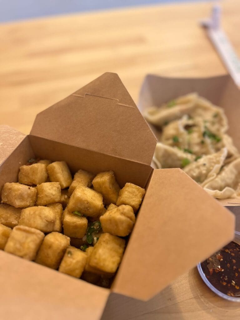 a box of food sitting on top of a wooden table