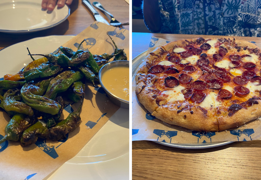 a pizza sitting on top of a plate of food on a table