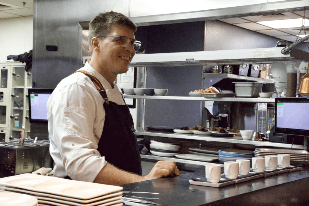 a man preparing food in a kitchen