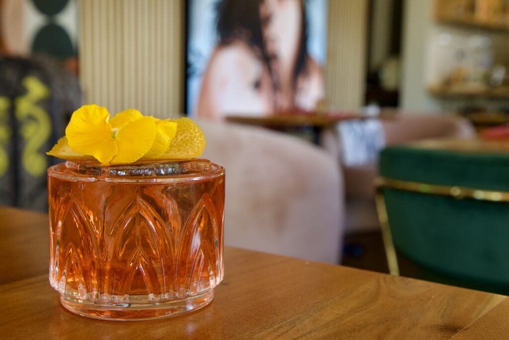 a glass of orange juice on a table