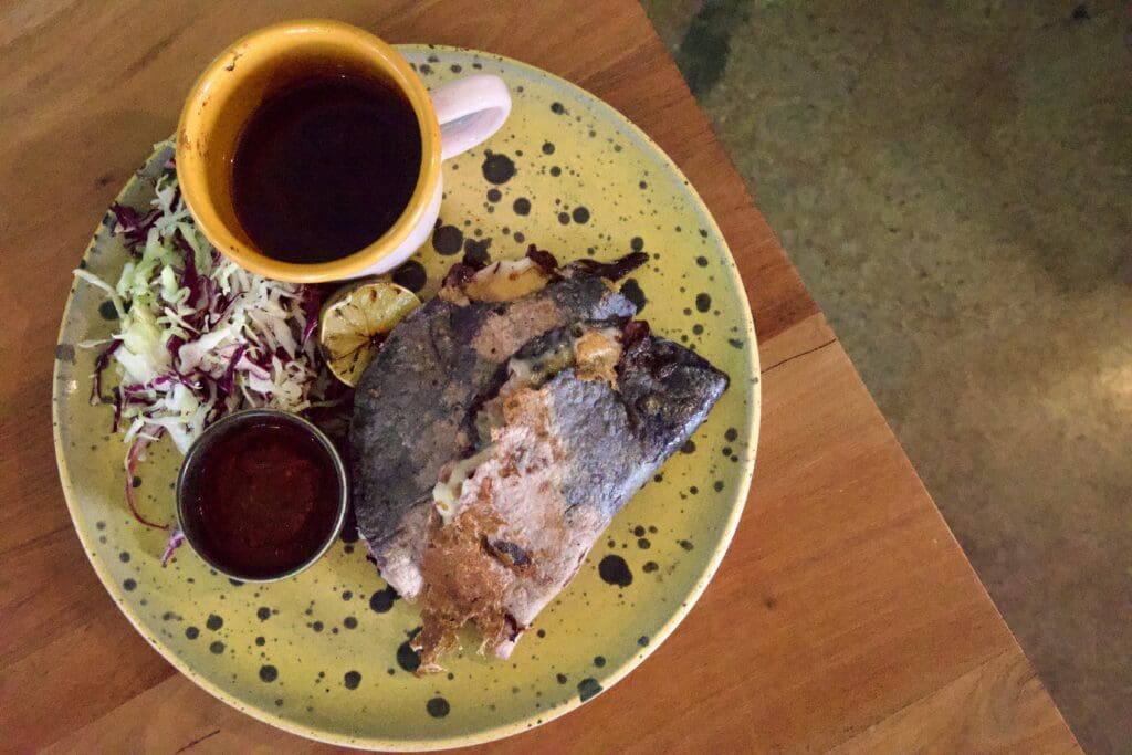 a plate of food and a cup of coffee
