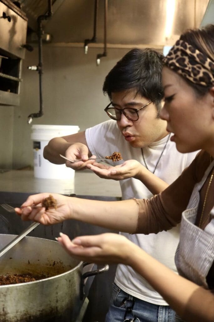 a woman cooking in a kitchen preparing food
