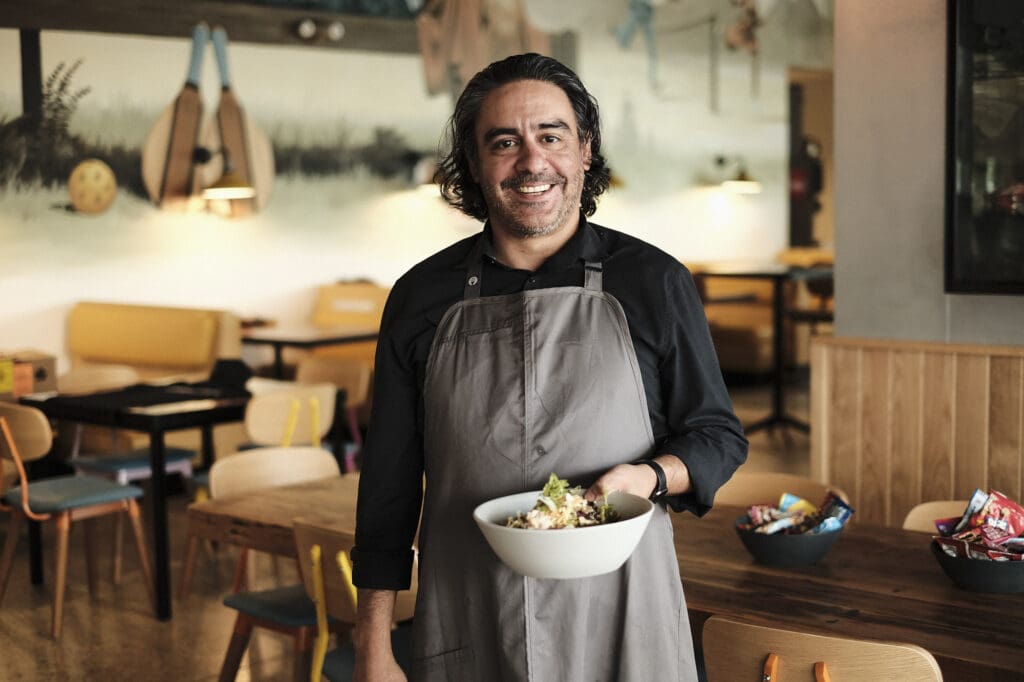 a person sitting at a table with a plate of food