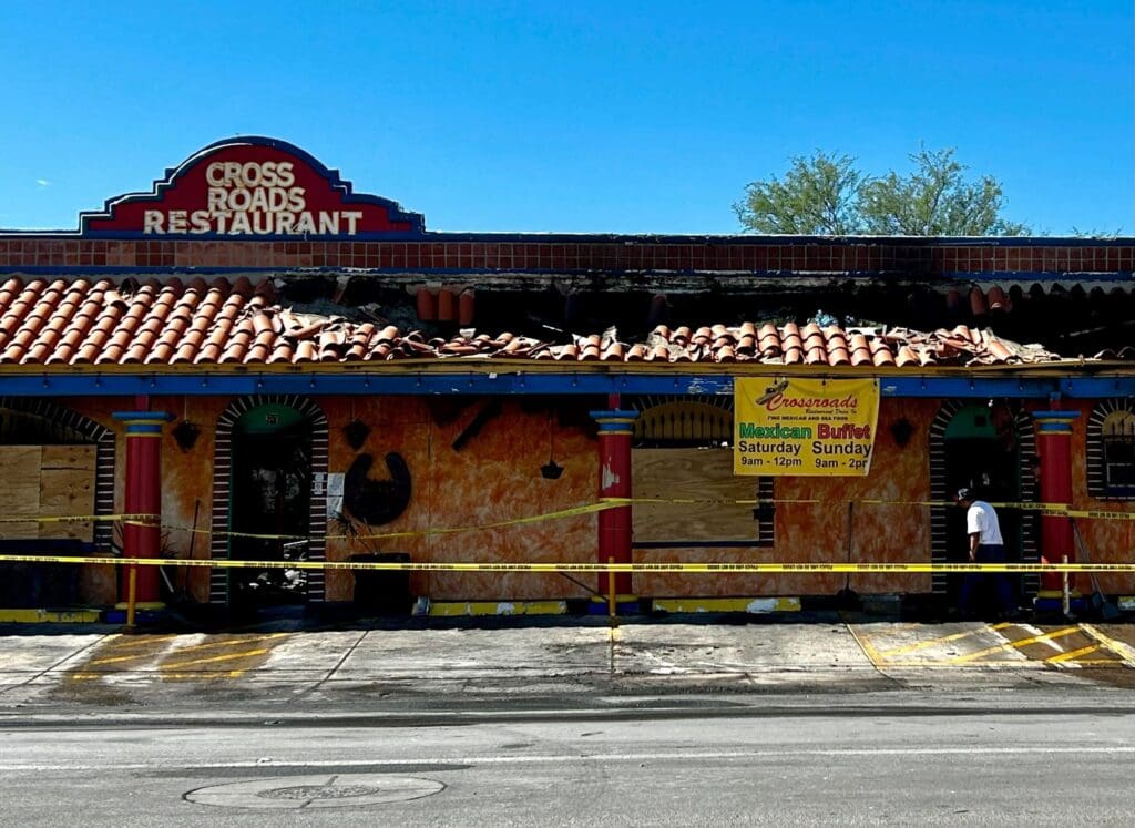 a building with graffiti on the side of a road