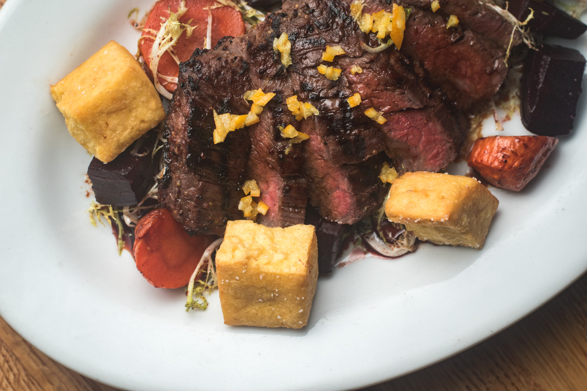 Grilled Marinated Flank Steak + Braised Carrots, Preserved Lemon, Chickpea Croutons at DOWNTOWN Kitchen + Cocktails (Credit: Jackie Tran)