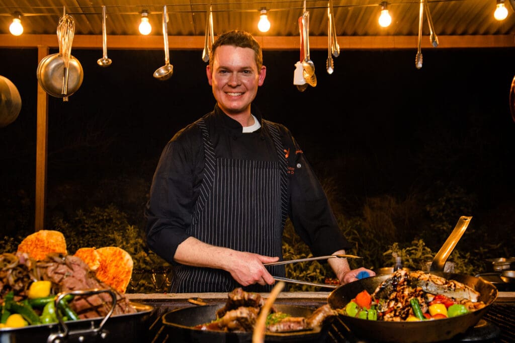 a man cooking food on a table