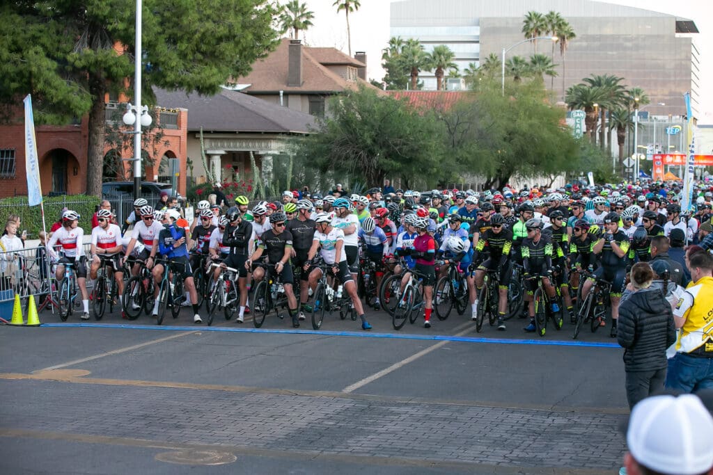 a group of people walking down the street in front of a crowd