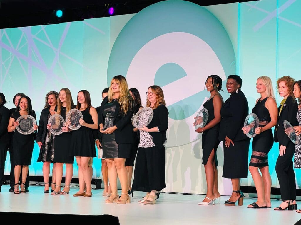 a group of people standing in front of a crowd posing for the camera