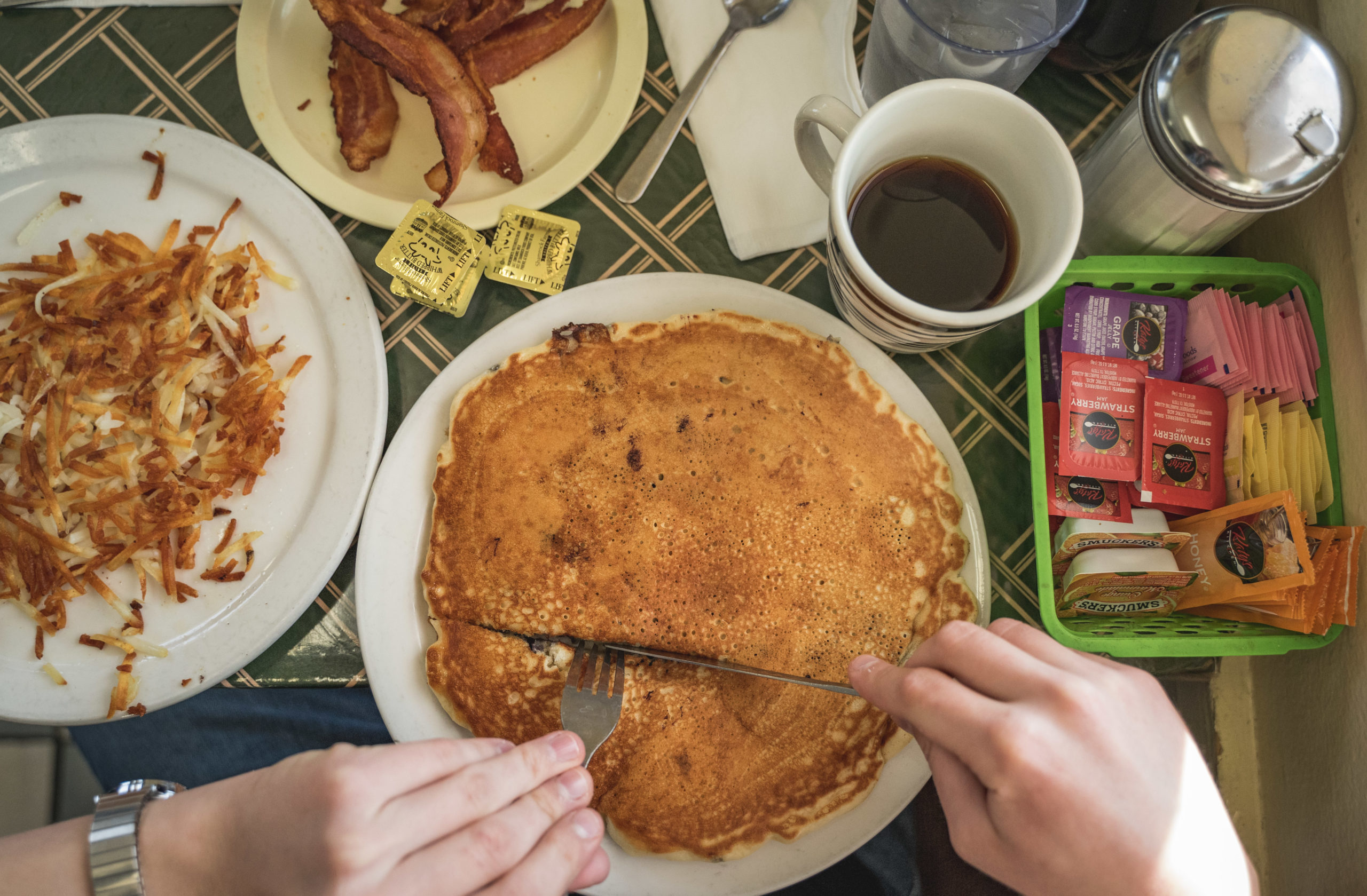 One pancake with a side of bacon and Hash Browns at Frank's