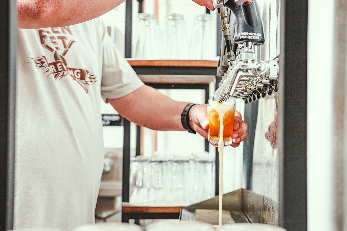 Scott Petersen pouring beer at Green Feet Brewing (Credit: Jackie Tran)