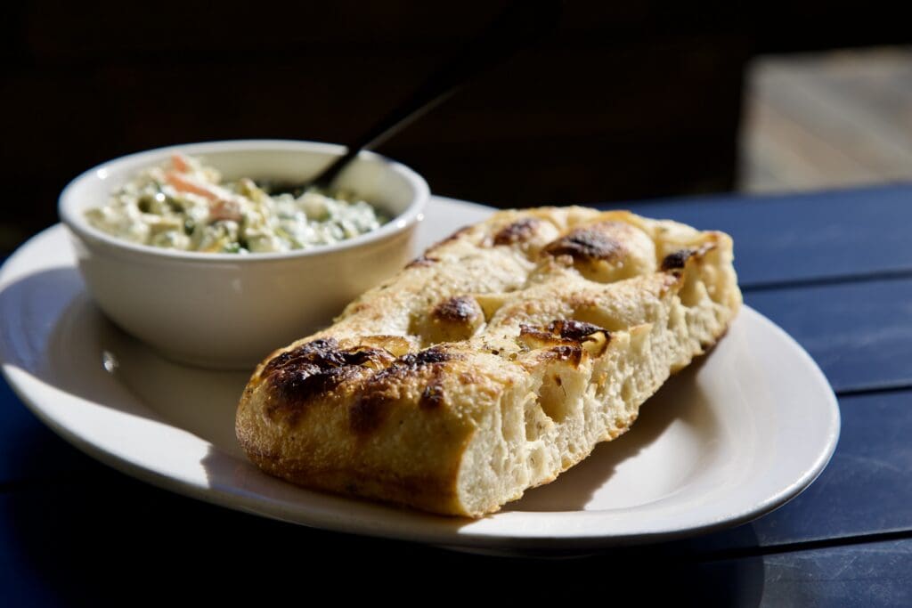 a piece of bread on a plate, focaccia