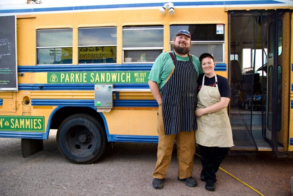 a man standing in front of a bus