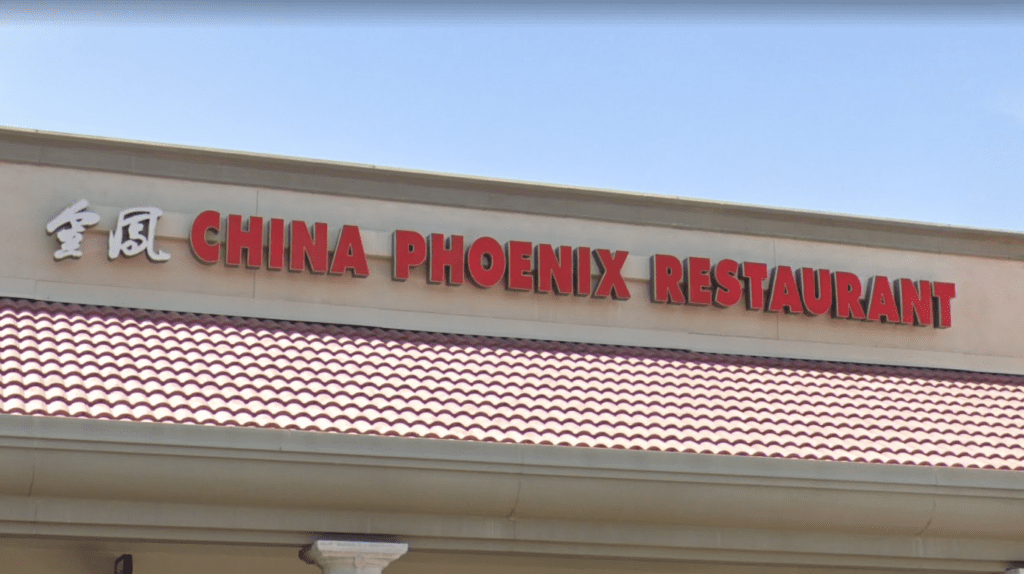 a sign in front of a building