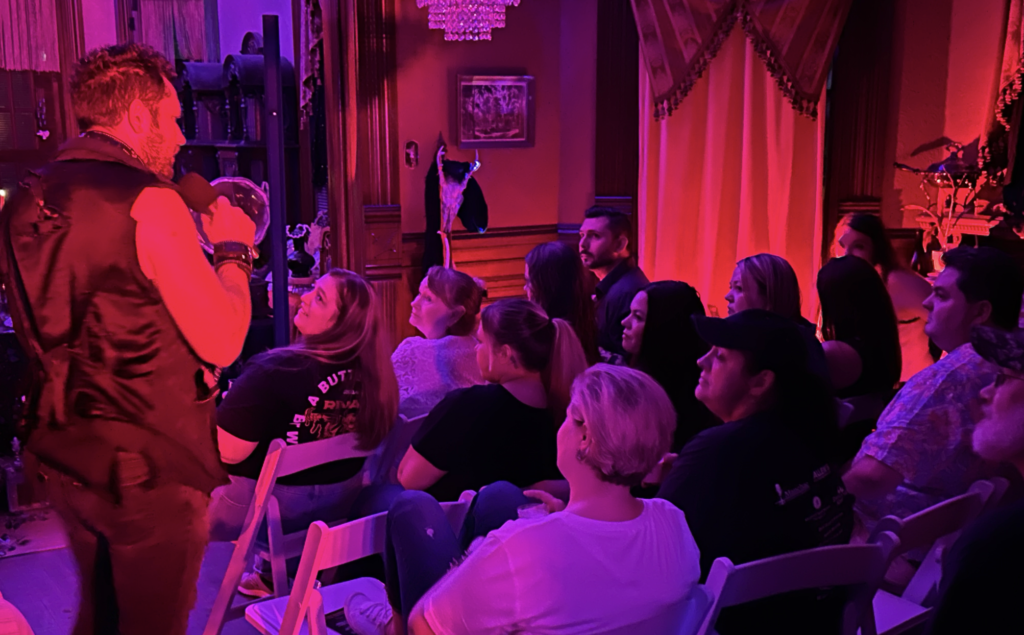 a group of people sitting on a stage in front of a crowd
