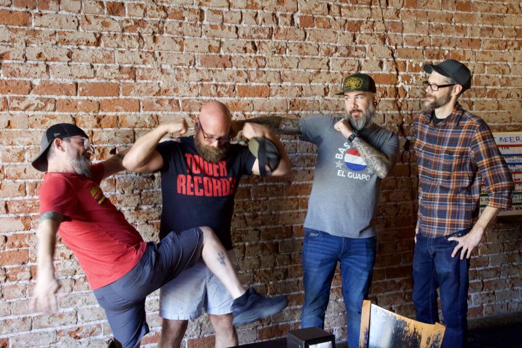 a group of people standing next to a brick wall