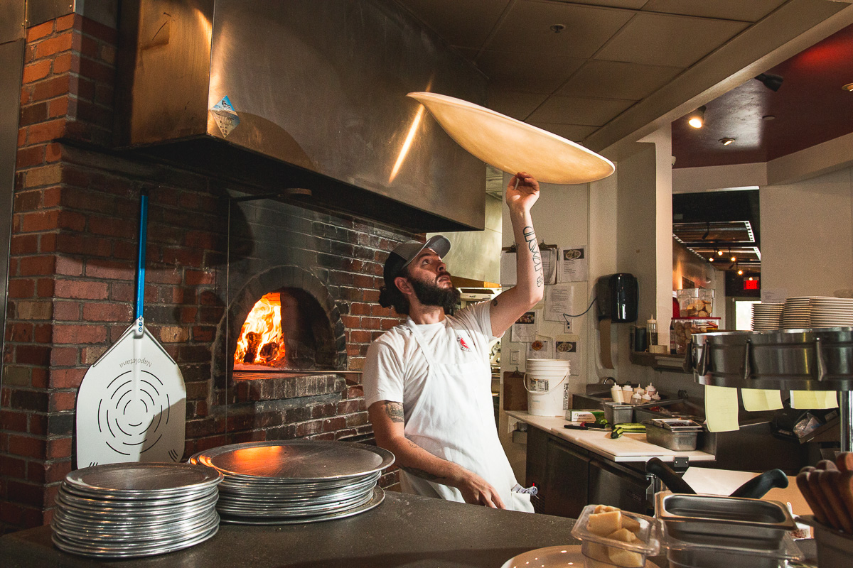 Eric Corbin tossing dough at Trident Pizza Pub (Credit: Jackie Tran)