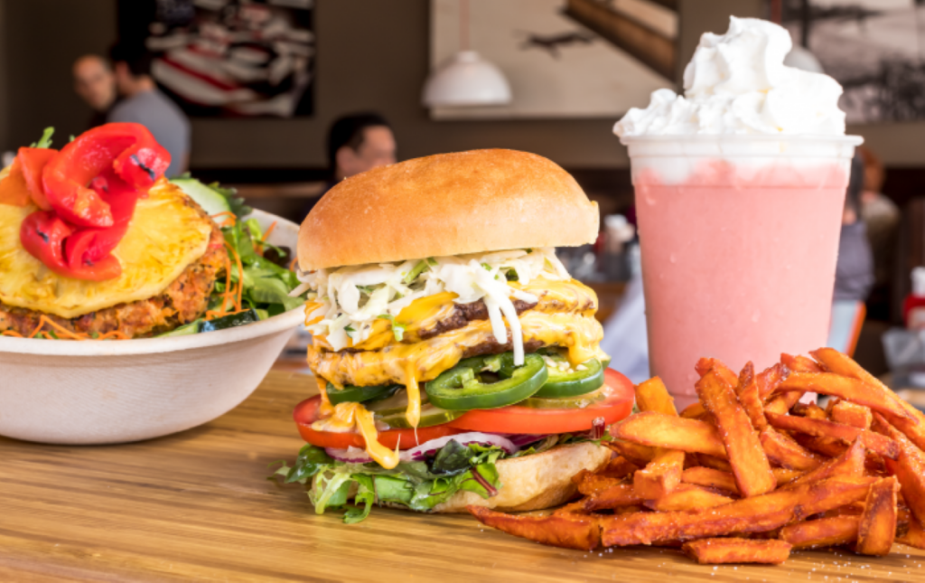 a close up of a sandwich and fries on a plate