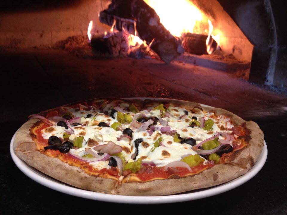 a pizza sitting on top of a fire place