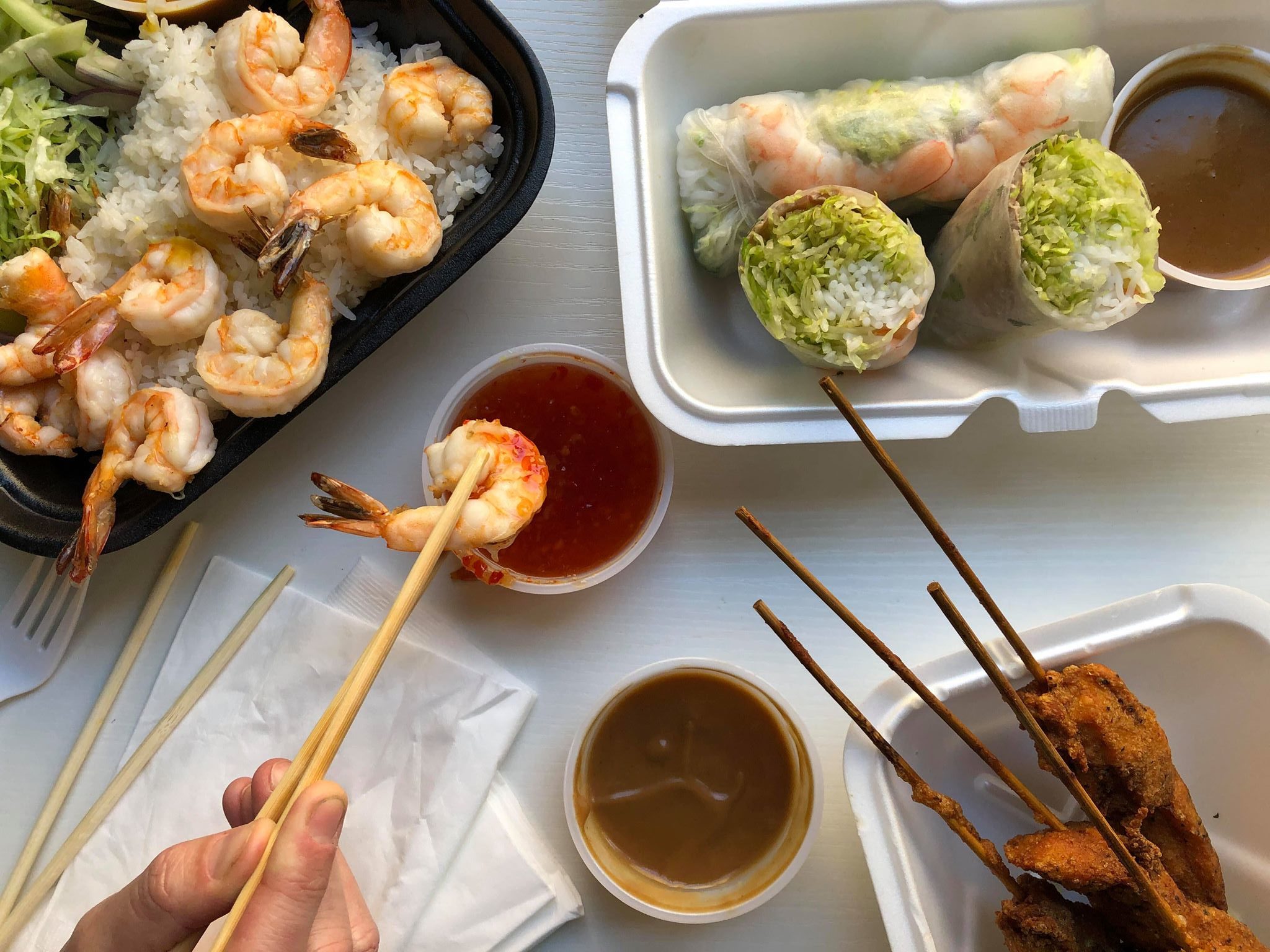 Grilled Shrimps topped with Coconut Curry Sauce on Jasmine Rice, Vietnamese Spring Rolls and Grilled Chicken Skewers with Peanut Sauce from Miss Saigon (Credit: Melissa Stihl)